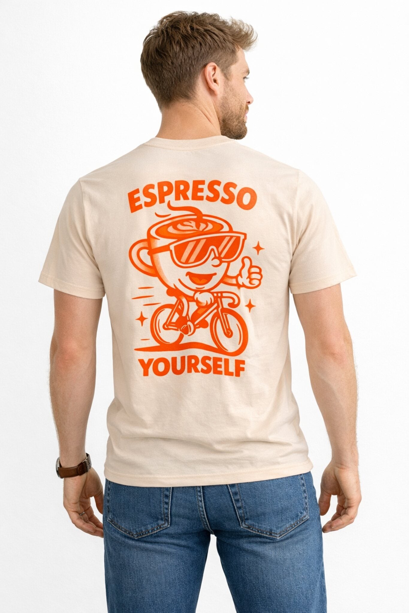 Man wearing a beige t-shirt with 'Espresso Yourself' graphic design on the back.