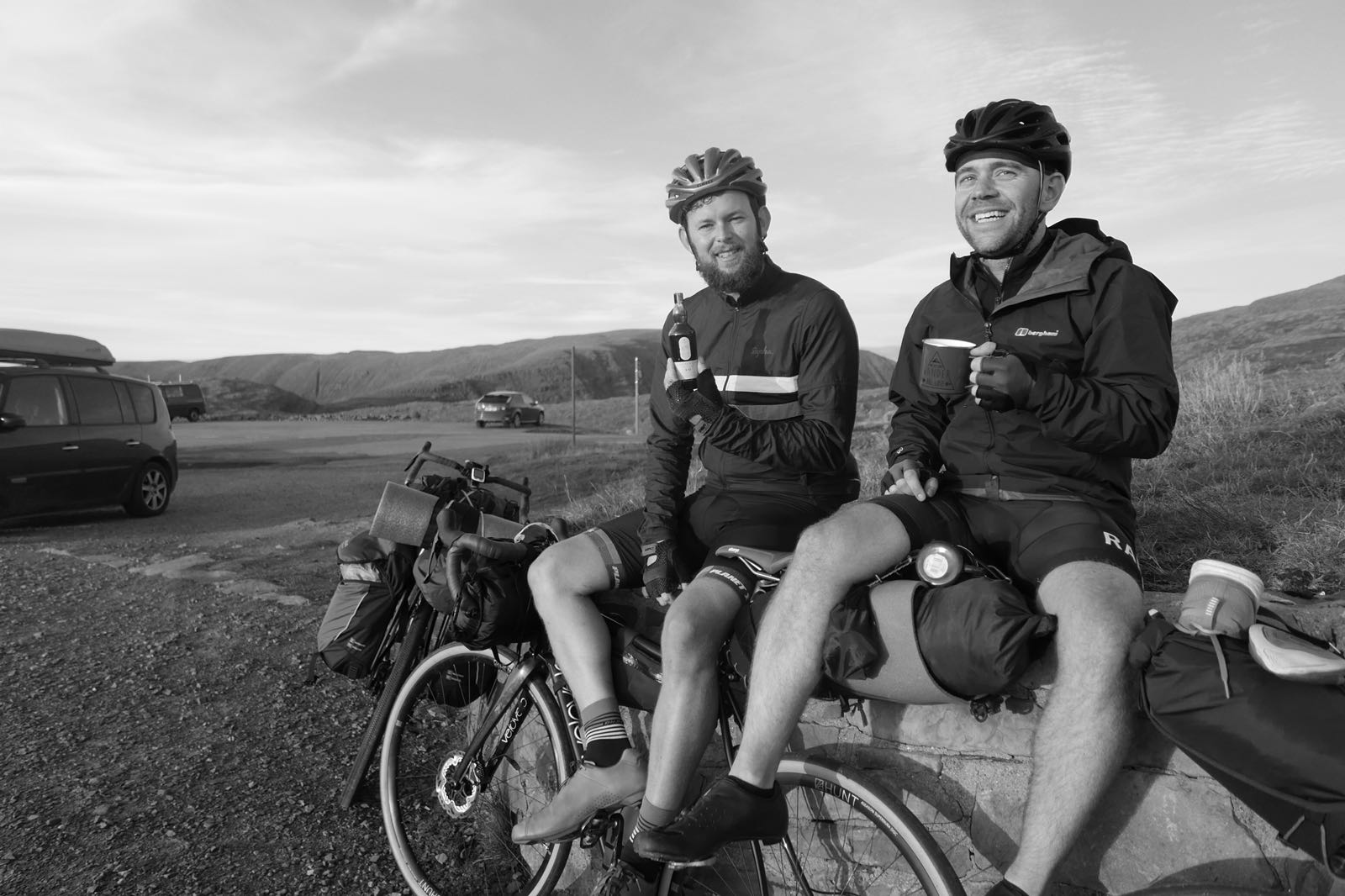 Jamie and Barry having whisky on top of a Scottish mountain, riding the North Coast 500 Scotland cycling route.