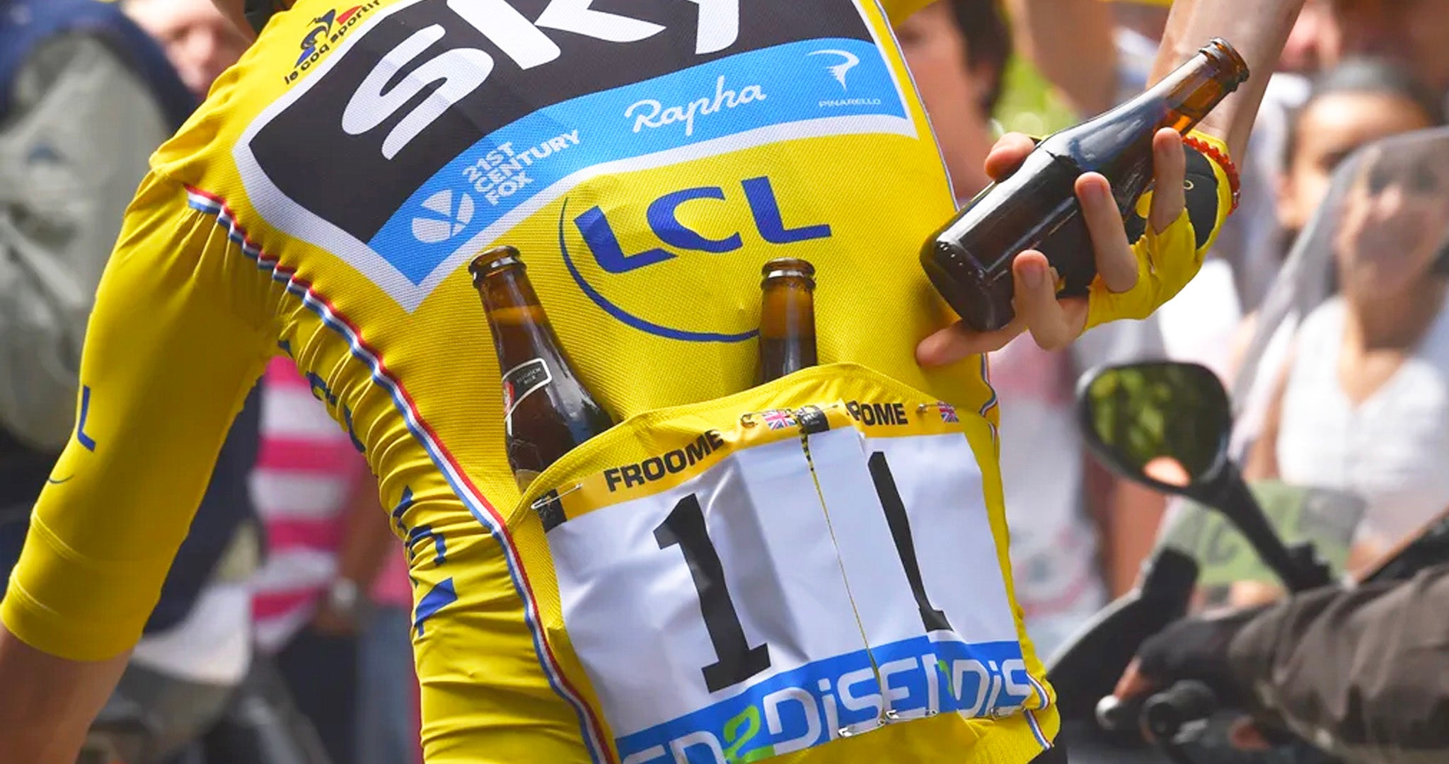 A close up of a member of the team winning the Team Award, showing the special yellow coloured race numbers pinned to their back.