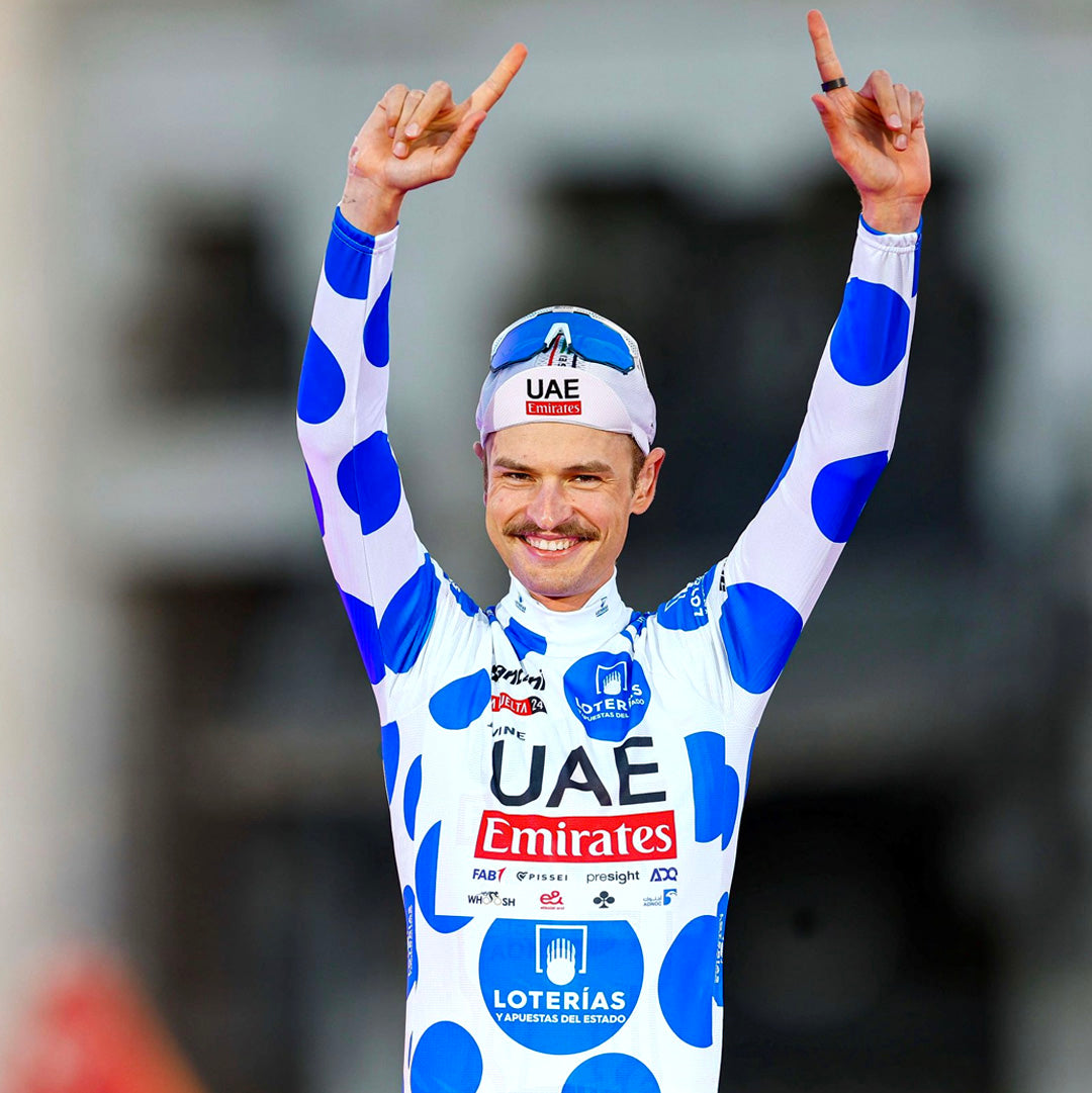 Winning a mountain stage of La Vuelta wearing the blue polka dot jersey.